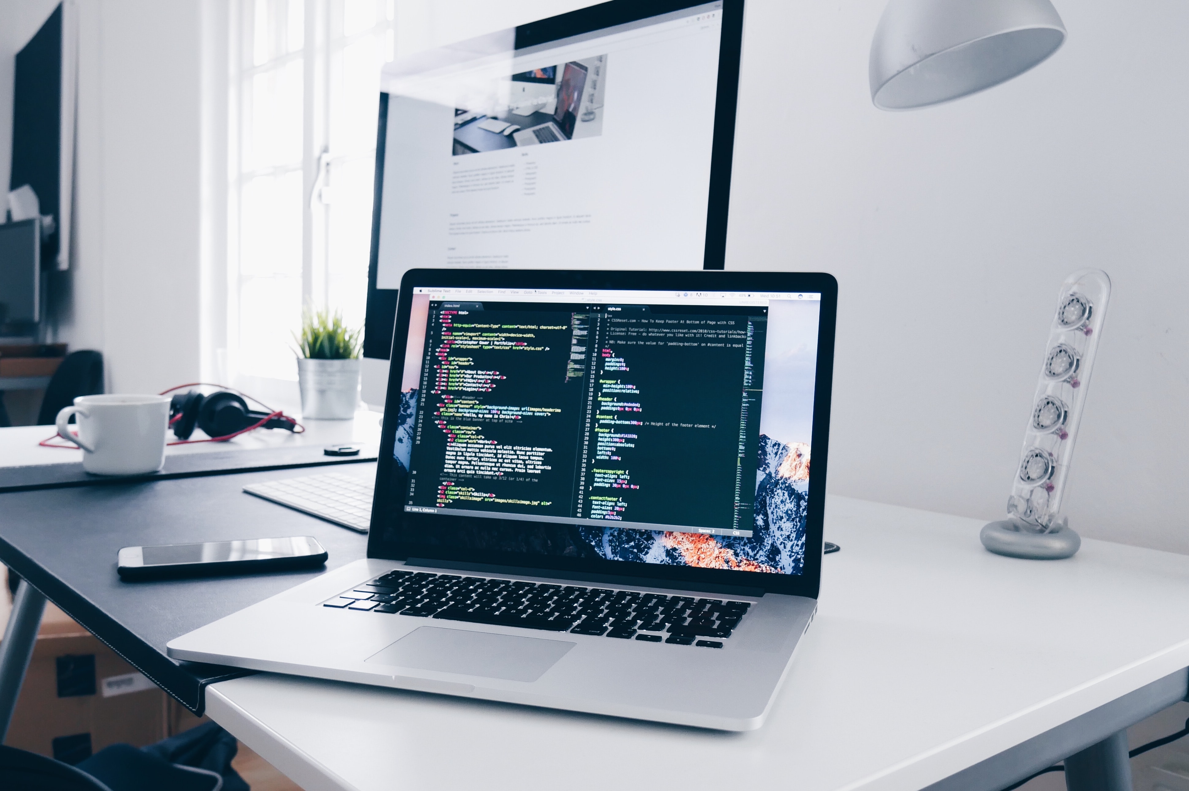 Two desktop on a table with bright background